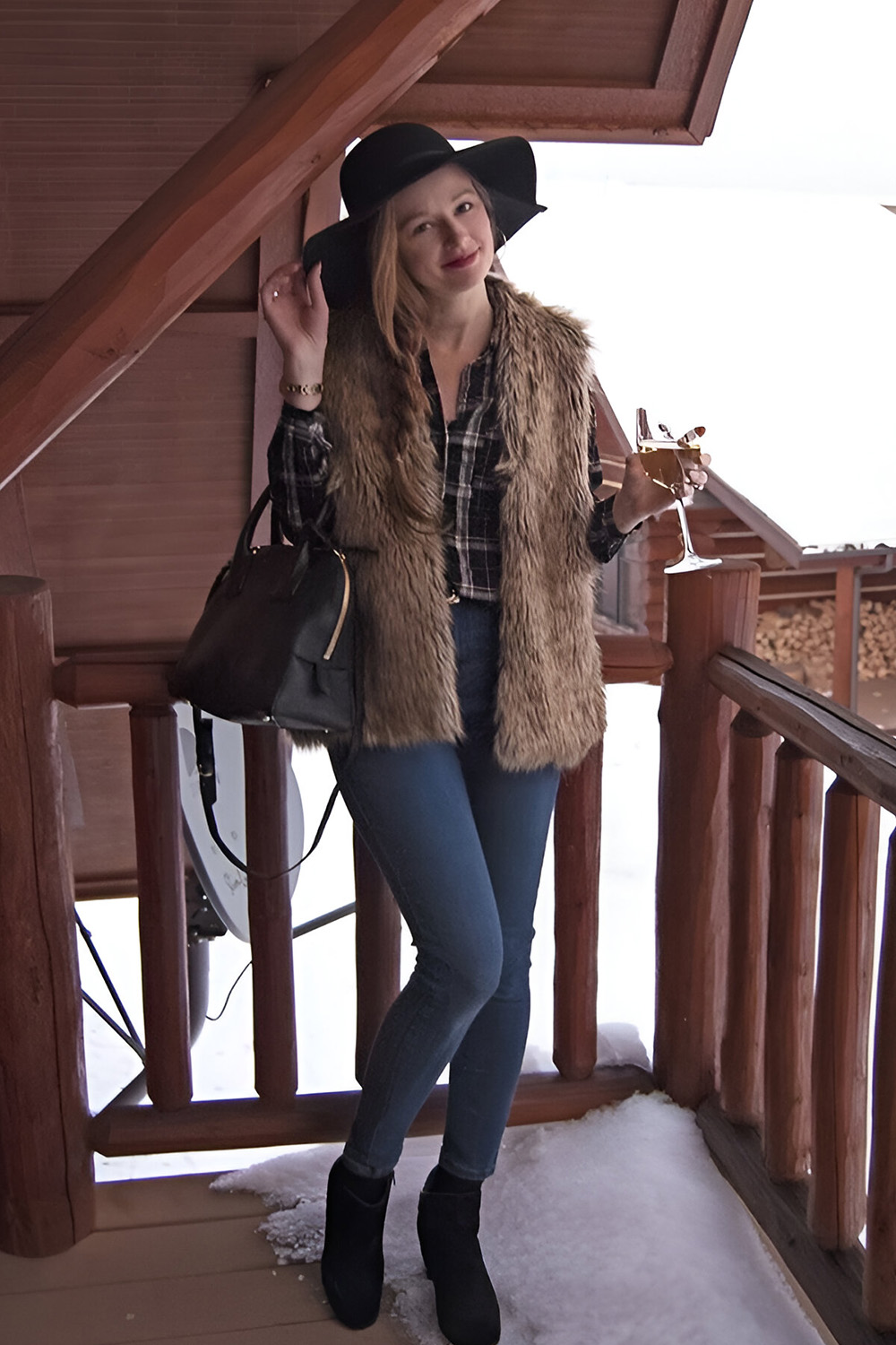 Faux fur vest and plaid shirt layered over denim