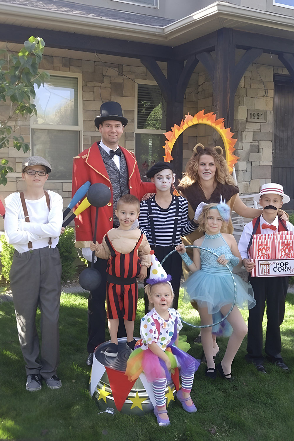 Family circus performer costumes with ringmaster and tiny lion baby