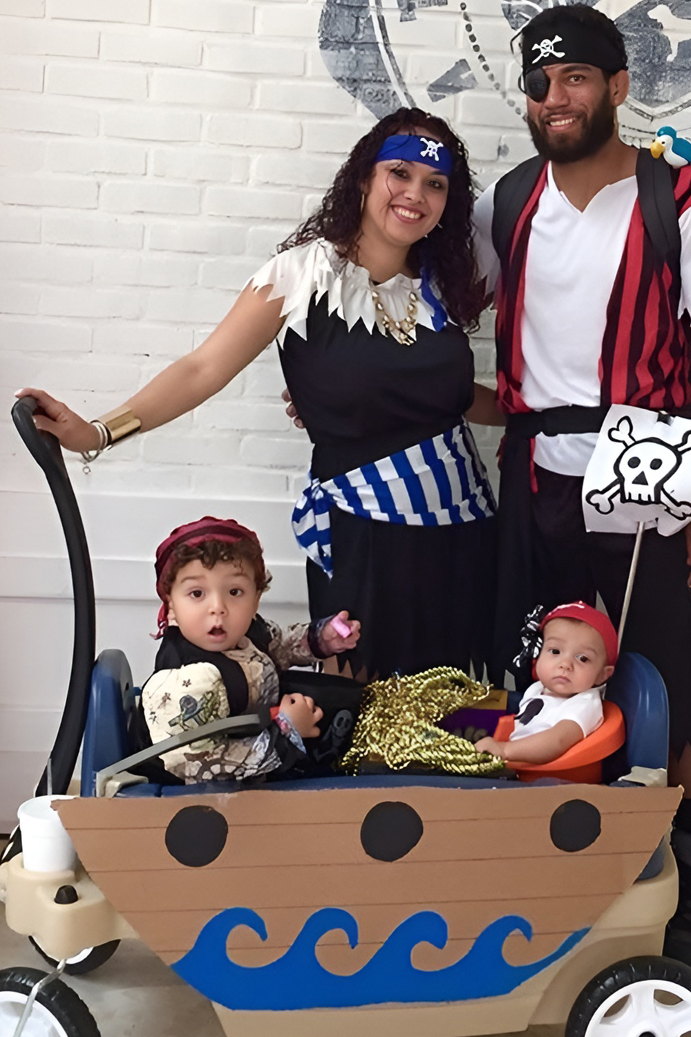 Family in pirate crew costumes with the baby as the littlest deckhand