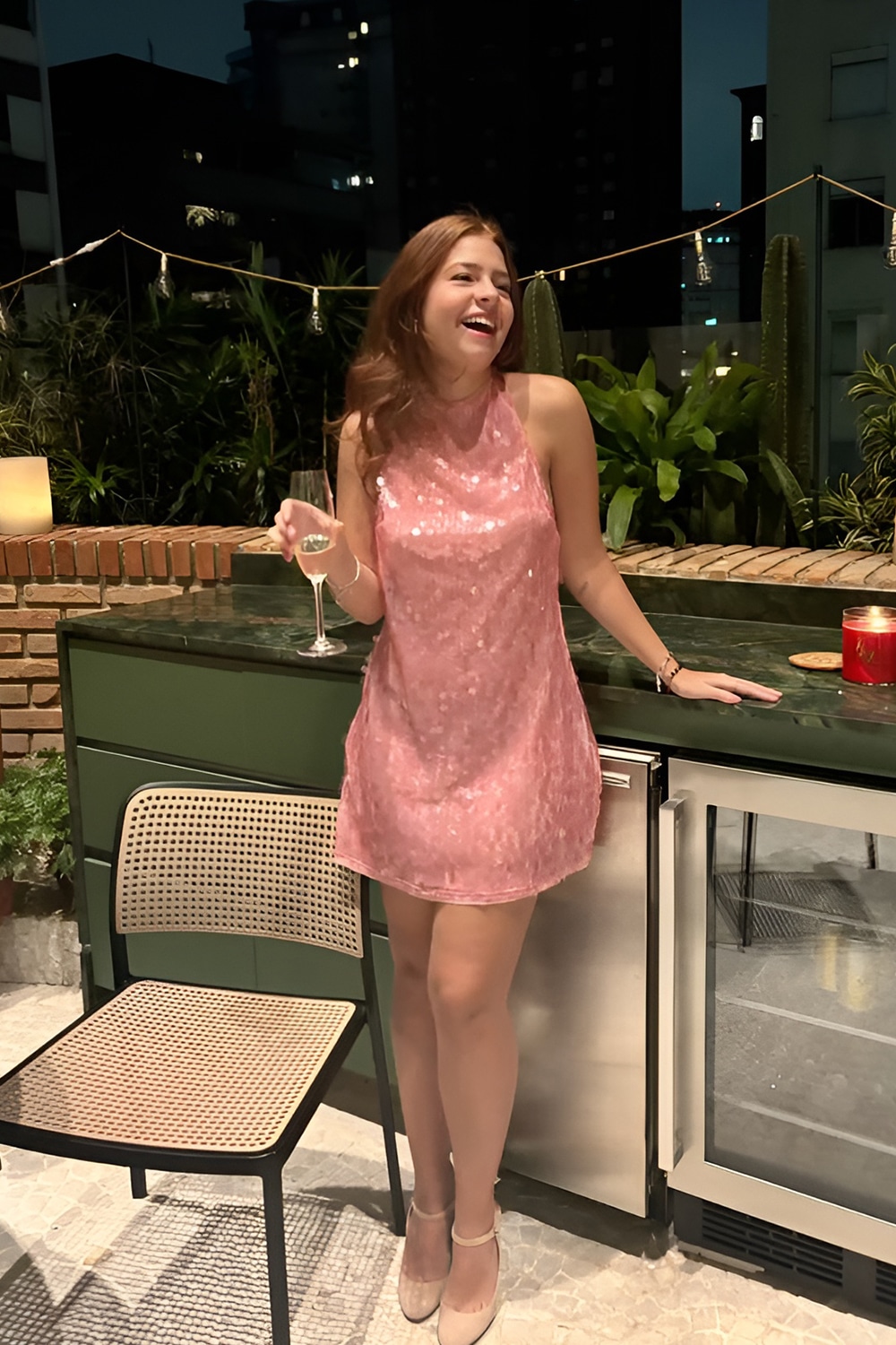 Woman in a sparkling sequin mini dress, glamorous New Year's Eve outfit