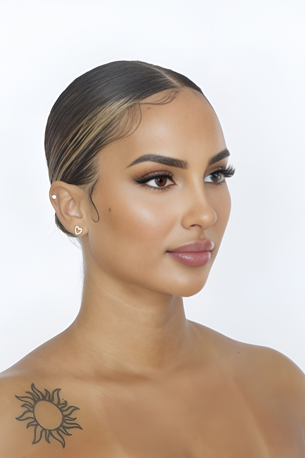 Low Polished Bun with a Clean, Glossy Centre Part